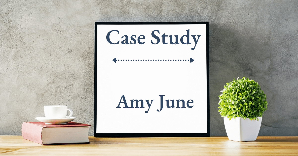 Desk with book, plant, and whiteboard that says "Amy June Case Study" (Amy June, NLBM-trained Personal Family Lawyer)