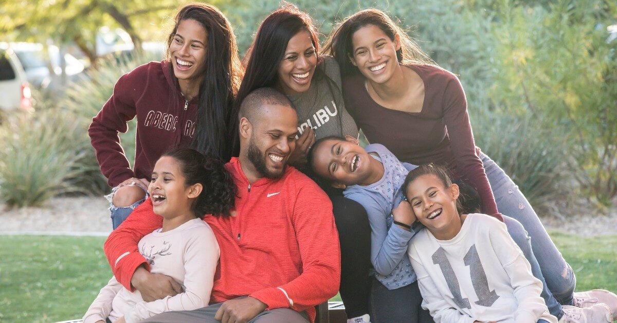 Shane Young, estate planning lawyer, with her husband and 5 daughters, laughing and enjoying outdoor time together.